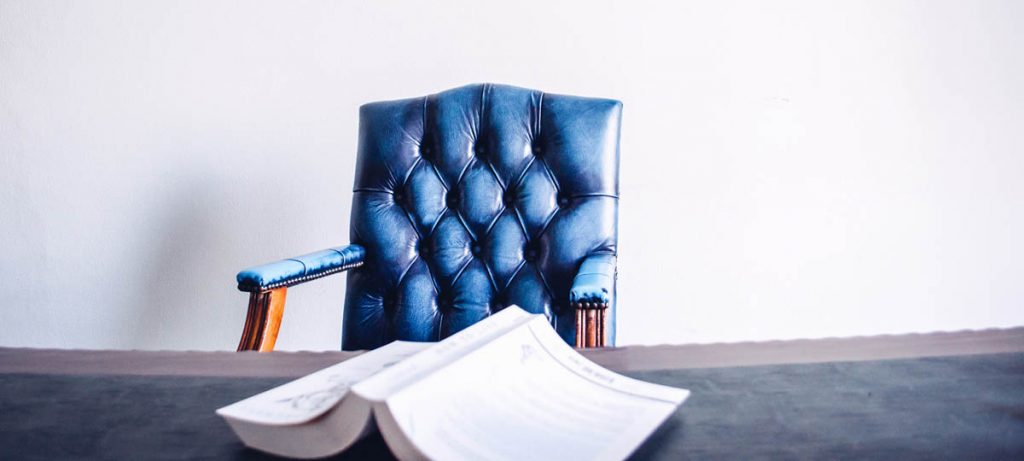 Blauwe bureaustoel met omgedraaid boek