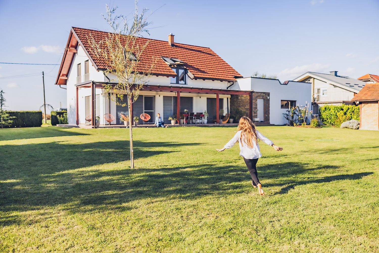 Fille court dans le jardin arrière d’une maison